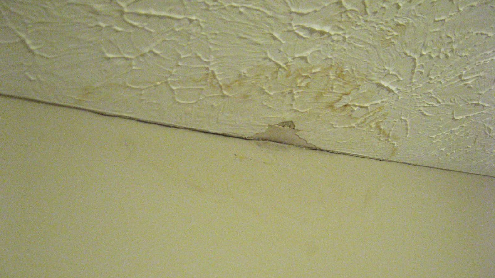 Interior wall and ceiling with visible water damage.